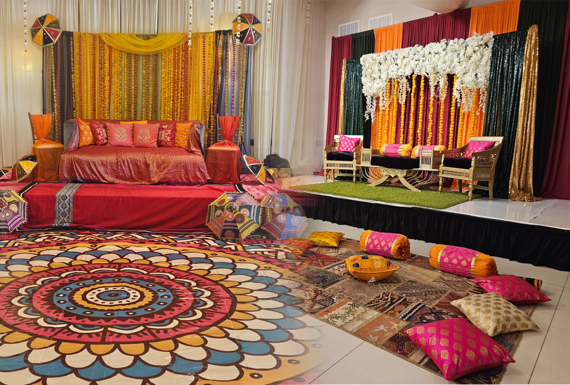 Colorful traditional mehndi and sangeet decor with floor seating at Signature Cuisine